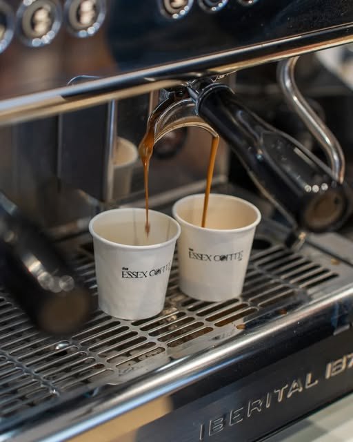 Two espresso shots pulling into Essex Coffee Co. branded cups